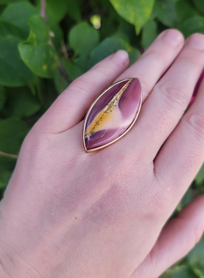 25.8 carat Mookaite .925 Sterling Silver brilliantly handcrafted ring s. 7 adjustable - Mookaite sterling silver ring worn on hand, close-up view.
