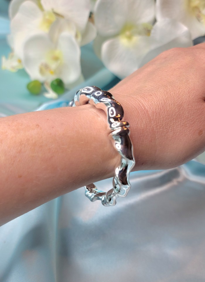 Precious Italy made Authentic .925 Sterling Silver handmade Bracelet - Sterling silver bracelet worn on wrist with floral backdrop.