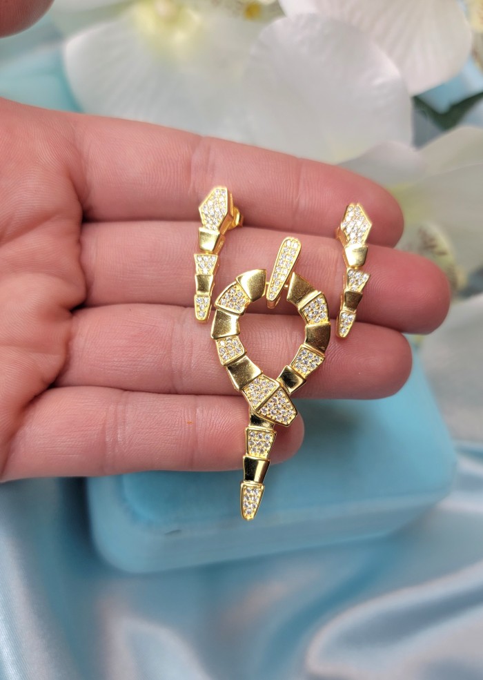 Cleopatra - The Egyptian Cobra White Sapphire 18K Gold over .925 Sterling Silver handcrafted Earrings - Jewelry held in hand; Cleopatra cobra design with white sapphires.